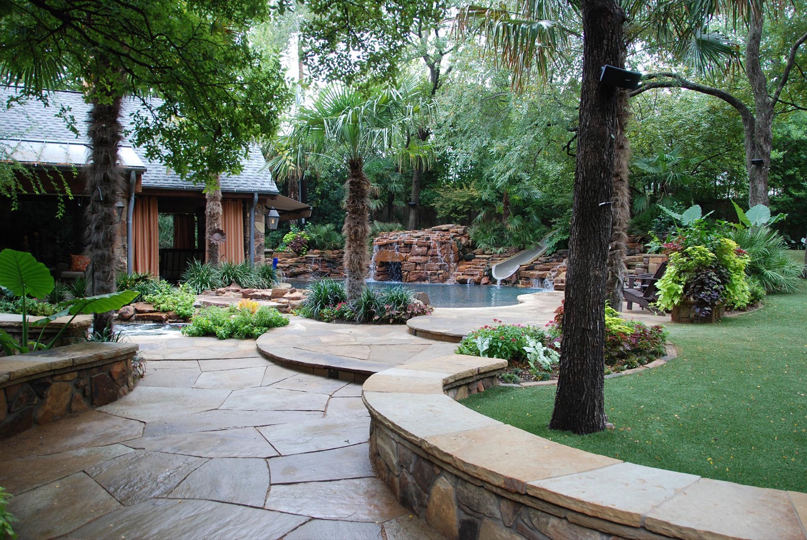 Deep shade garden retreat with flagstone pool in Dallas by landscape design firm