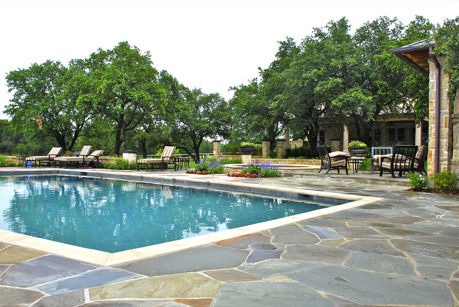 French Country estate pool flagstone deck in Dallas by landscape design firm