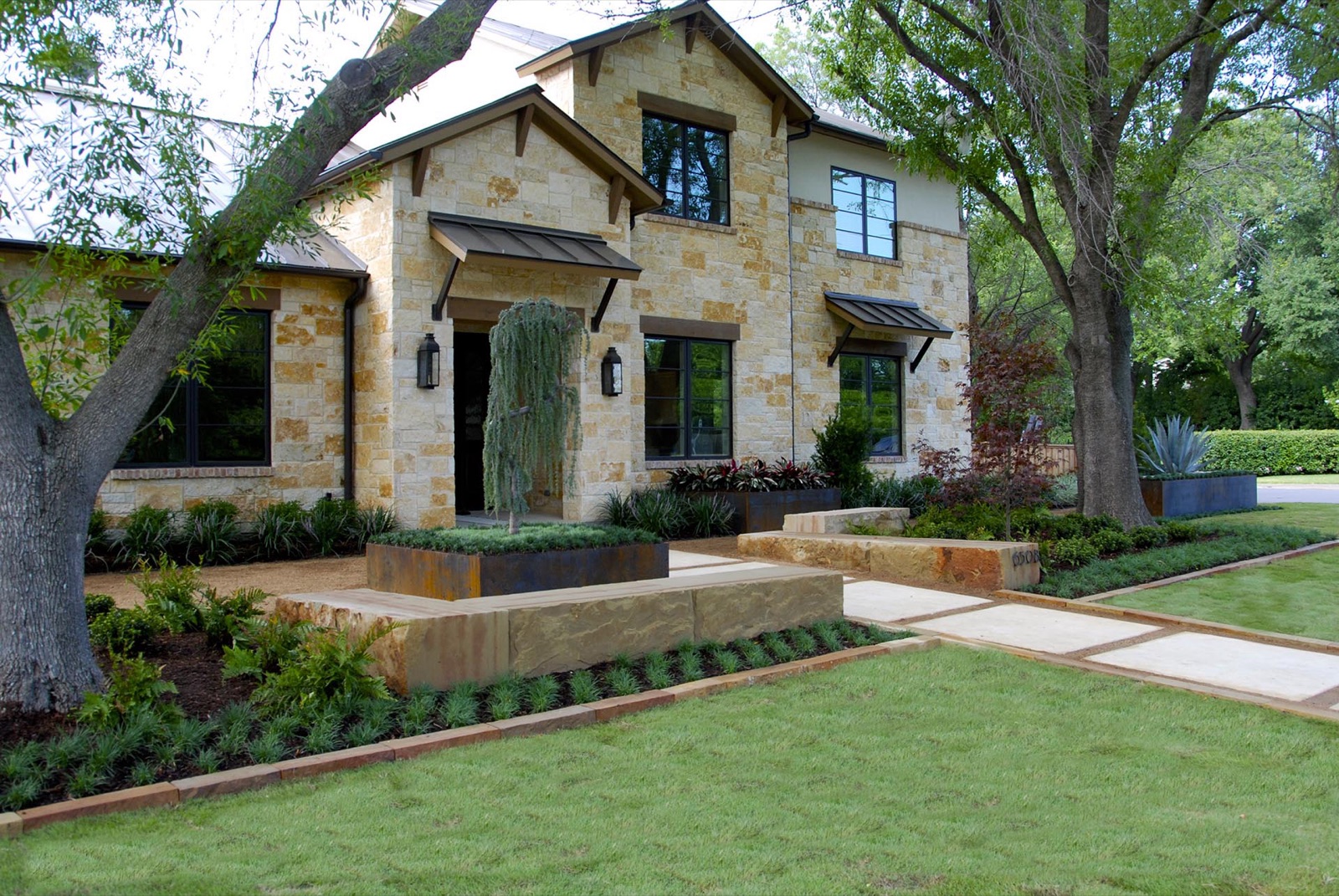 Modern Hill Country front landscape with quarry stone in Dallas by landscape design firm