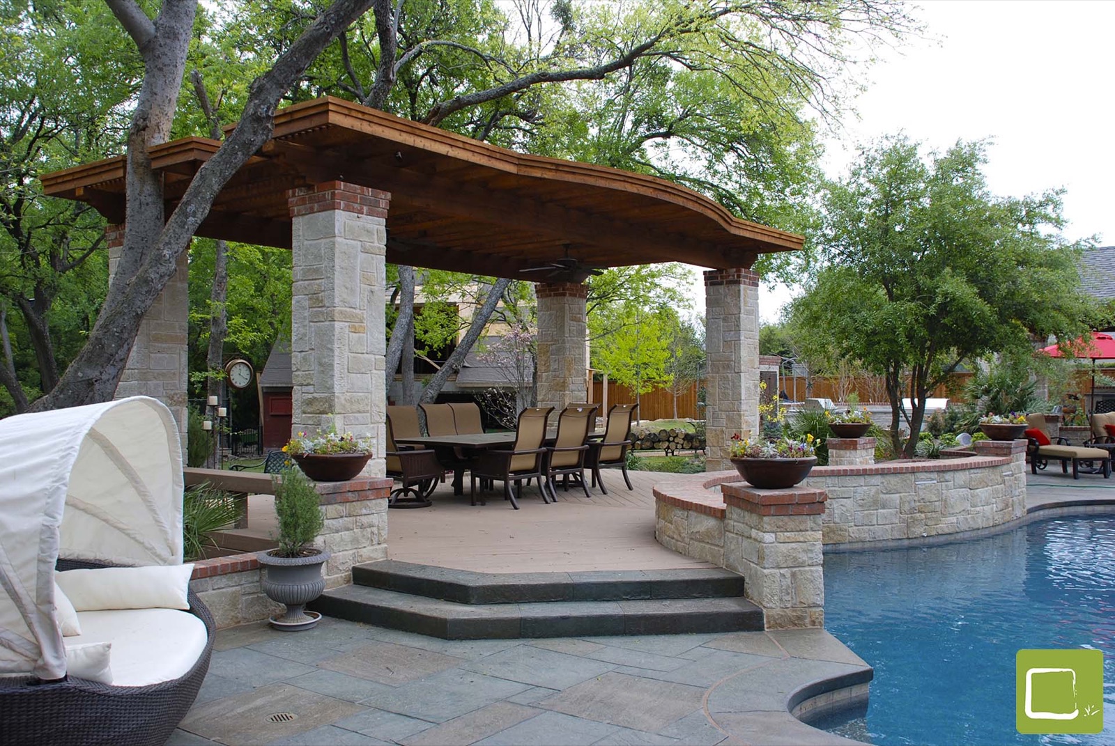 Transitional pool courtyard with arbor stone in Dallas by landscape design firm